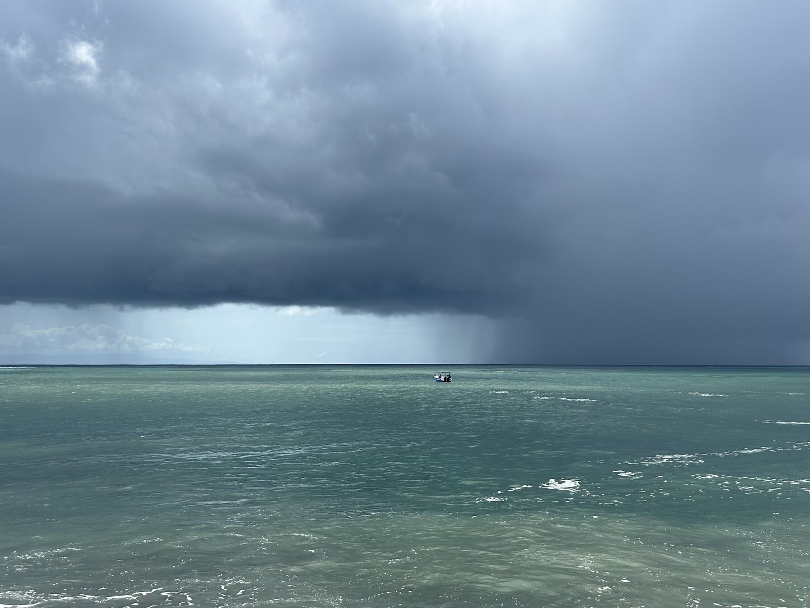 Light breaking on the horizon beneath a passing storm off the Montezuma coast