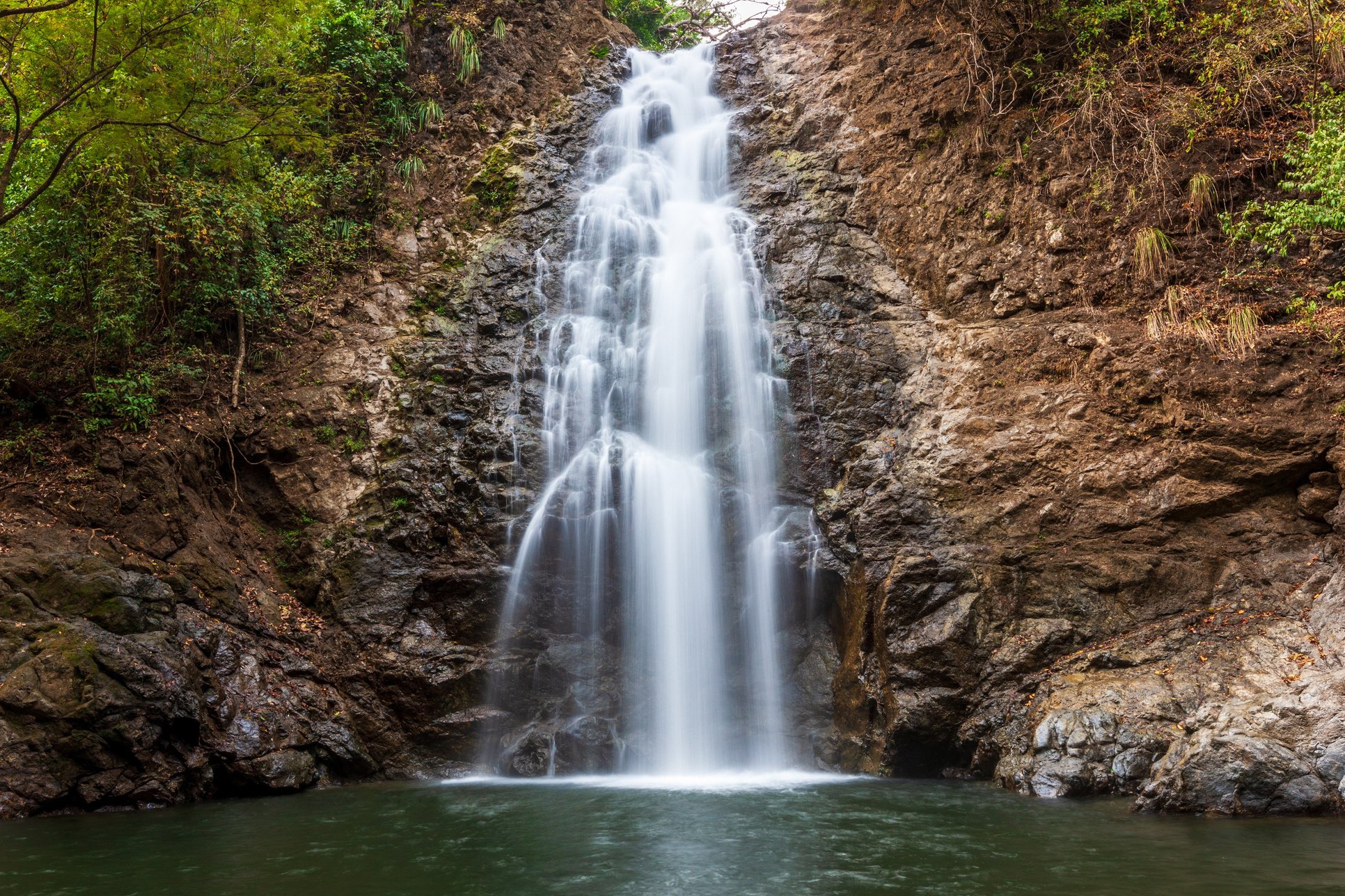 Montezuma waterfall pouring into a turquoise pool surrounded by jungle